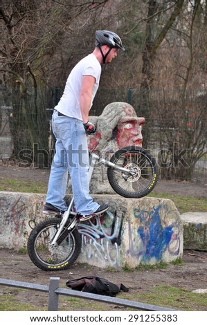 BERLIN MARCH 6: Unidentified male jumping on the bicycle (over 15% people in Berlin prefer moving by bike) on March 6, 2015.