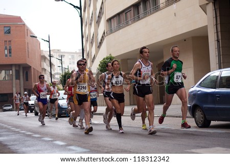 ALBACETE - APRIL 9: Unidentified runners on the street during Albacete half marathon on April 9, 2010 in Albacete, Spain