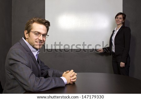 Conference room with blank screen for logo space