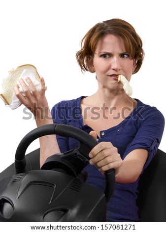 female driver eating a sandwich while driving
