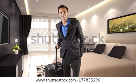 young caucasian businessman travelling with luggage or baggage in a hotel