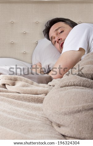 man unable to sleep because of loud noise