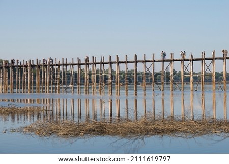 View of the old wooden bridge U Bein on a sunny evening. Amarapura, Myanmar