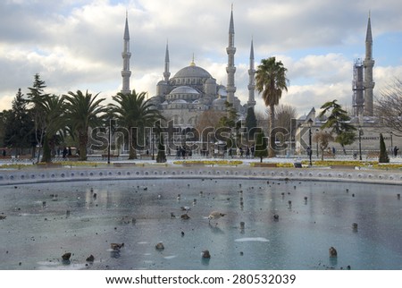 ISTANBUL, TURKEY - JANUARY 09, 2015: A cold winter day. Frozen city fountain and the Blue mosque
