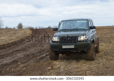 LENINGRAD REGION, RUSSIA - APRIL 05, 2015: UAZ-Patriot stands on a muddy field road