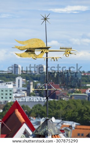 Metal weather vane-rooster over the city. Tallinn, Estonia