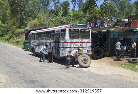 KANDY, SRI LANKA - MARCH 19, 2015: Replacement of the broken wheel on the Shuttle bus