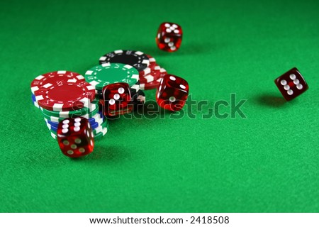 Action shot of 5 dice thrown onto a table - fast shutter showing dice in the air
