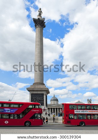 LONDON, ENGLAND - MAY 30: Nelson\'s Column and double - deckers in Trafalgar Square on May 30, 2015 in London