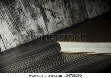 Vintage book, open, on old wooden table, with clipping path
