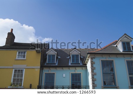 18th century roofline, windows and frontages in English market town, with blue sky space for text. Viewed from public location.