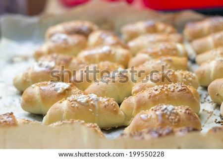 Stack of freshly baked golden mini croissants in a baking pan