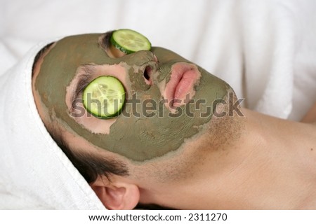 someone having a mask in a spa with cucumber slices on the eyes
