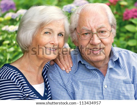 Happy senior couple portrait,outdoors,close-up