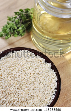 Sesame seeds in ceramic plate with  Sesame oil on table