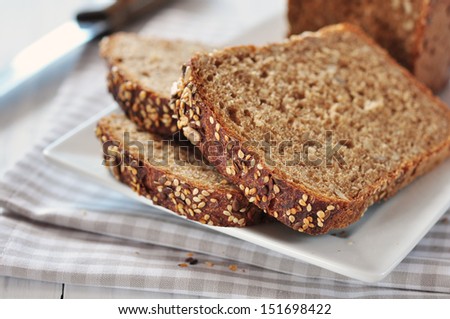 Sliced bread with sunflower seeds and sesame on a plate Stock foto © 