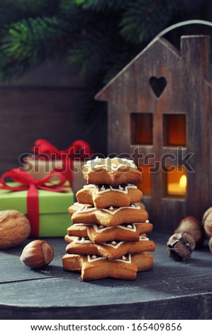 Fir tree from ginger biscuits with lantern and gift boxes on a wooden background