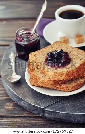 Breakfast with toast, fruit jam and coffee on tray