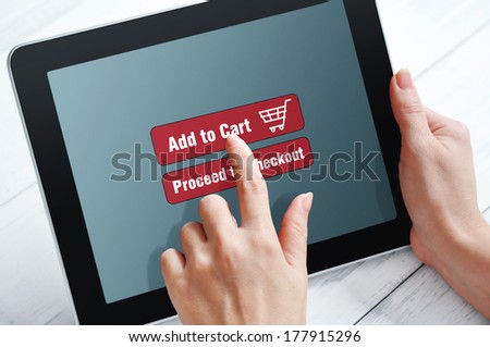 Female hands using touch screen device for online shopping