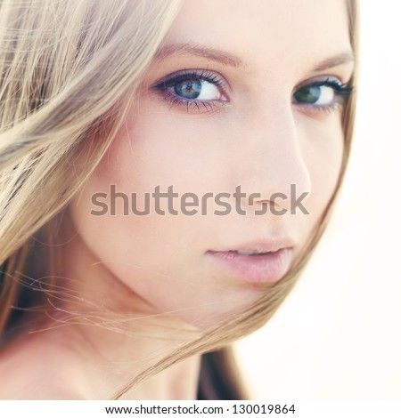 face of a beautiful girl with perfect skin closeup