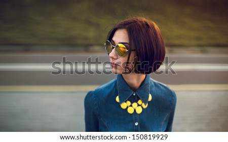 portrait of a beautiful girl in hipster glasses