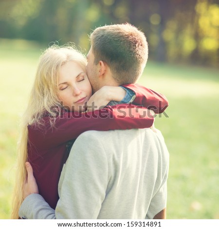 beautiful blonde woman in love hugging her boyfriend