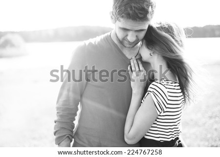 beautiful happy couple in love hugging on the beach on a sunny day. black and white photo