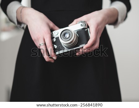Vintage camera in female hands