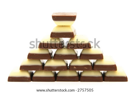 pyramid made of white and dark chocolates isolated on white
