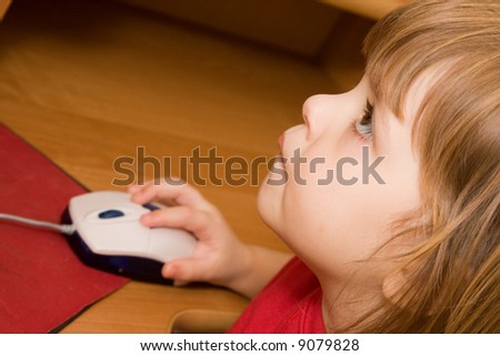 little, cute girl playing  computer game, close up