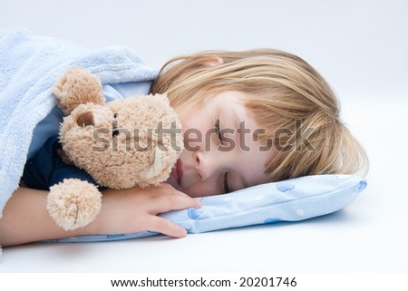 little girl sleeping and hugging her teddy bear