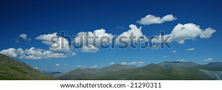 Background - blue sky, white clouds and green hills, Altai, Russia