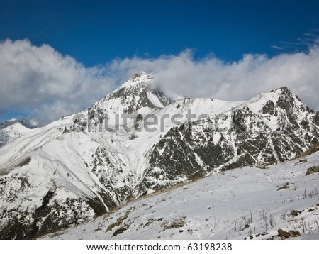 Caucasian mountains, Elbrus, wild mountain landscape, snow-clad  high peaks, snow and blue sky
