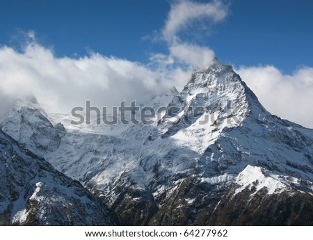 Caucasian mountains, Elbrus, Cheget, wild mountain landscape, snow-clad  high peaks, snow and blue sky