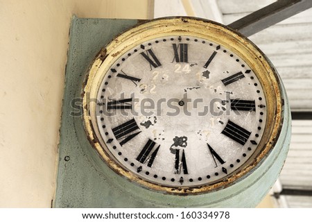 Old railway clock face with roman numerals at an old station in France