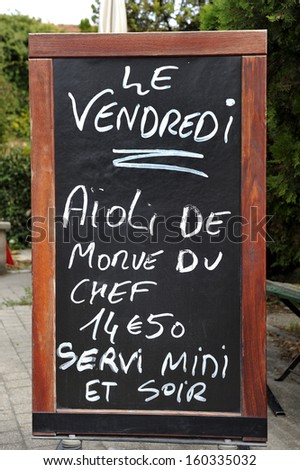 Outside menu sign for aioli diner at French restaurant