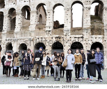ROME,ITALY-MARCH 5, 2015;Young Japanese tourists in front of the Colosseum.This is an UNESCO world heritage site.March 5,2015 Rome, Italy