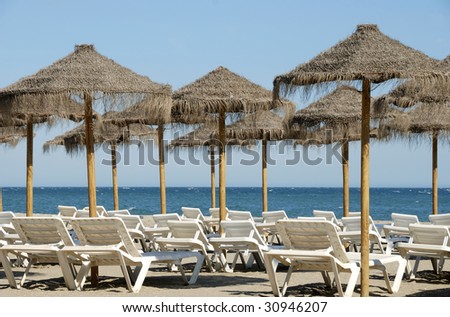 Beach chairs and sun shades without people