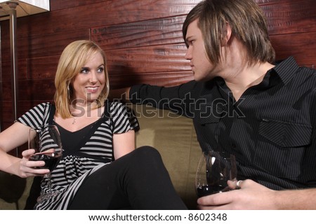 Man and woman in conversation at a wine lounge