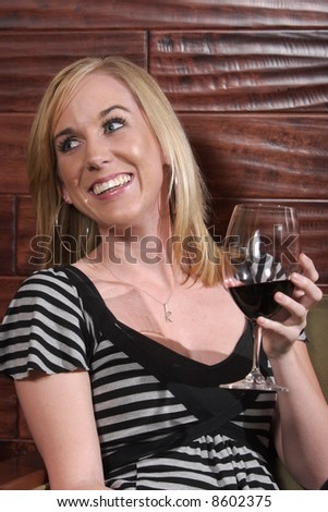 Woman laughs during a conversation in a wine lounge