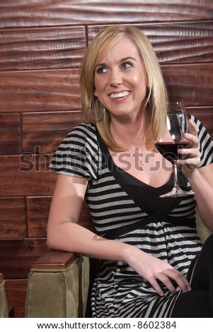 A woman laught during a conversation at a wine lounge
