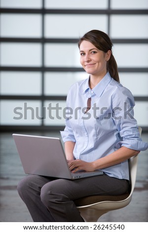 Business woman laptop in modern lobby