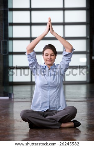 Business woman yoga at a modern office