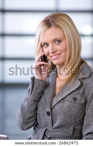 Business woman on a cell phone in a modern office