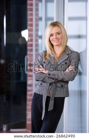 Business woman arms crossed in a modern office