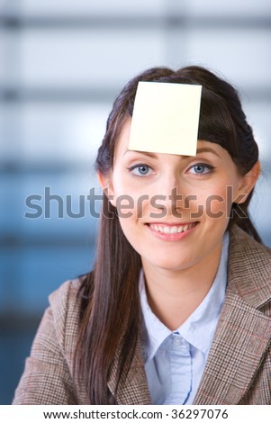 Business Woman post it on head in modern office