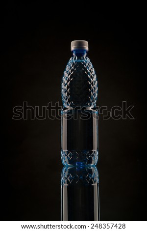 Small juice bottle over  black  background