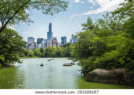 Lake in central park and New York city skyline