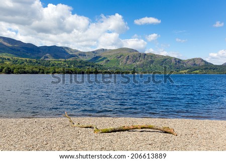 Coniston lake The Lakes National Park England uk on a beautiful sunny blue sky summer day popular tourist attraction with mountains in background