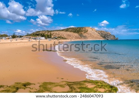 Similar – Image, Stock Photo Sandy seashore near hill with houses under cloudy sky